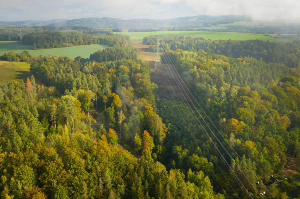 Aerial view of the high voltage power lines and high voltage electric transmission on the terrain